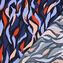 Load image into Gallery viewer, EcoVero Viscose Fabric with abstract flames print shown with reverse side folded onto itself