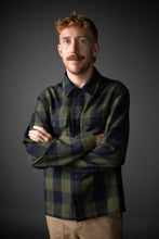 Load image into Gallery viewer, Male wears a checked long sleeved collared shirt, arms crossed across front