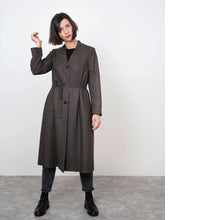Load image into Gallery viewer, Lady stands wearing a V-Neck Coat fastened with buttons and tie belt at waist