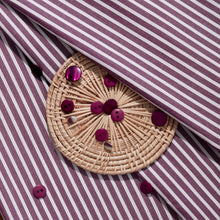 Load image into Gallery viewer, Close up of Stripe Sunray Viscose Modal fabric with wicker coaster of buttons lain on top