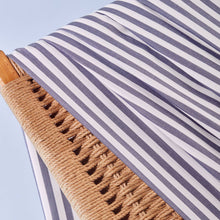 Load image into Gallery viewer, Close-up of stripey Viscose Modal fabric hangs over wicker chair