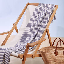 Load image into Gallery viewer, Stripey Viscose Modal fabric drapes across a deckchair
