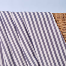 Load image into Gallery viewer, Close-up of stripey Viscose Modal fabric hangs over wicker chair