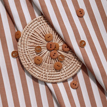 Load image into Gallery viewer, Close up of Sunray Stripe Viscose Modal fabric with wicker coaster of buttons on top