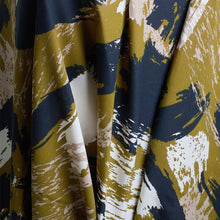 Load image into Gallery viewer, Atelier Brunette's Mira Viscose fabric hangs to show drape close-up, with an abstract brushstrokes pattern print