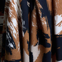 Load image into Gallery viewer, Atelier Brunette's Mira Viscose fabric hangs to show drape close-up, with an abstract brushstrokes pattern print
