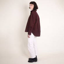 Load image into Gallery viewer, Side view of model wearing long sleeve shirt made with Oxford Cotton Fabric