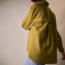 Load image into Gallery viewer, Side view of model wearing long sleeved shirt made with Oxford Cotton Fabric
