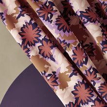 Load image into Gallery viewer, Diagonal view of viscose fabric hanging with a waterlily abstract print on it