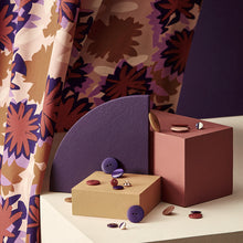 Load image into Gallery viewer, Waterlily abstract print on viscose fabric hangs behind a display of buttons and blocks