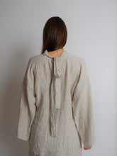 Load image into Gallery viewer, Back view of lady wearing a long sleeved, high neck Zero Waste Top with ties at the back neck