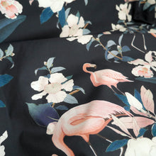 Load image into Gallery viewer, Cotton fabric with floral and flamingo pattern, displayed with drape