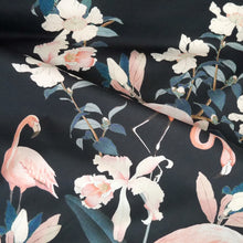 Load image into Gallery viewer, Cotton fabric with floral and flamingo pattern, displayed with soft folds