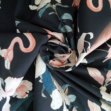 Load image into Gallery viewer, Cotton fabric with floral and flamingo pattern, displayed with central swirl