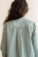 Load image into Gallery viewer, Back view of lady wearing Butano Button Up showing a hanging loop from the yoke