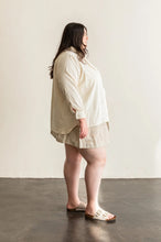 Load image into Gallery viewer, Side view of lady wearing long sleeved Butano button Up shirt