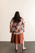 Load image into Gallery viewer, Back view of lady wearing a Butano Button Up, worn with skirt