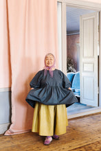 Load image into Gallery viewer, Lady wears a knee length dress, gathered at the waist over a wide gathered skirt in contrasting colour
