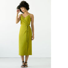Load image into Gallery viewer, Lady wears a wrap dress with waist tie.