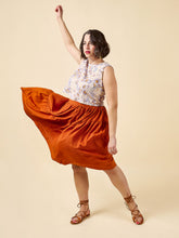 Load image into Gallery viewer, Model wears Azure sleeveless top, with asymmetric above knee length skirt, swishing the skirt