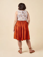 Load image into Gallery viewer, Back view of model wearing Azure sleeveless top, with asymmetric above knee length skirt