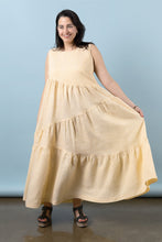 Load image into Gallery viewer, Model wears Azure Dress: a sleeveless top with asymmetric tiered skirt, holding out the skirt