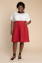 Load image into Gallery viewer, Lady wears an asymmetrical wrap Fiore Skirt, knee-length flare skirt