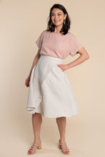 Load image into Gallery viewer, Lady wears an asymmetrical wrap Fiore Skirt, below-knee length flare skirt with single hip pocket