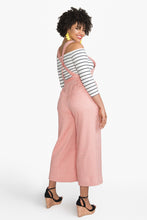 Load image into Gallery viewer, Side back view of lady wearing Jenny overalls with cross over straps at back