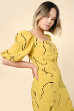 Load image into Gallery viewer, Model wears the Pauline Dress; showing off a square neckline, short puff sleeves