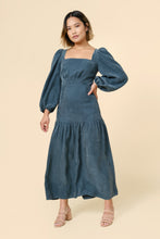 Load image into Gallery viewer, Model wears the Pauline Dress; a square neckline, long puff sleeves, maxi skirt including a gathered panel at above-knee level