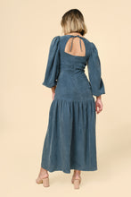 Load image into Gallery viewer, Back view of model wearing the Pauline Dress; keyhole opening in the back bodice tied at the nape of the neck. Maxi length, with gathered panel at knee-level