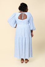 Load image into Gallery viewer, Back view of model wearing the Pauline Dress; keyhole opening in the back bodice tied at the nape of the neck. Maxi length, with gathered panel at knee-level