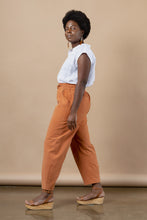 Load image into Gallery viewer, Side profile of model wear barrel leg trousers with large patch pockets and drawstring paperbag waist