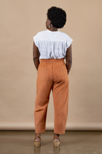 Load image into Gallery viewer, Back view of model wearing barrel leg trousers with patch pockets and drawstring paperbag waist