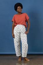 Load image into Gallery viewer, Model wears barrel leg trousers with large patch pockets and drawstring paperbag waist, in cotton ikat fabric