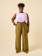 Load image into Gallery viewer, Model wears wide leg trousers with large patch pockets and drawstring paperbag waist