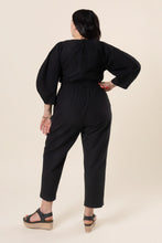 Load image into Gallery viewer, Back view of lady wearing Jo Jumpsuit with hand on hip