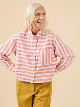 Load image into Gallery viewer, Lady wears a short cropped button up shirt in stripey fabric, and single chest patch pocket