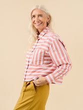 Load image into Gallery viewer, Lady wears a short cropped button up shirt in stripey fabric, long sleeved with cuff, and single chest patch pocket
