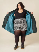 Load image into Gallery viewer, Model wears the Phoebe Coat held open to show contrasting colour lining