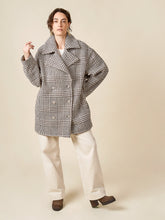 Load image into Gallery viewer, Model wears the shortened version of the Phoebe Coat, an double breasted coat, with dramatic notched collar