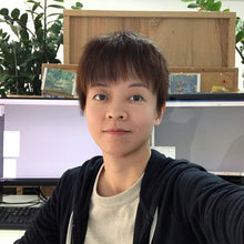 Load image into Gallery viewer, Designer Ophelia Pang sits at a workspace