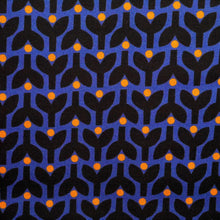 Load image into Gallery viewer, Organic cotton fabric displayed flat shows print of stems and dots in tessellating pattern