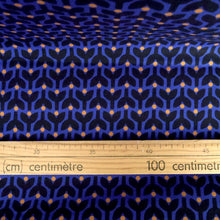 Load image into Gallery viewer, Organic cotton fabric shown with wooden ruler alongside print of stems and dots in tessellating pattern