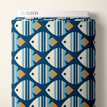 Load image into Gallery viewer, Bolt of Cloud9 Fabrics Organic Cotton with fish print, lays against wall