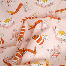 Load image into Gallery viewer, Organic cotton fabric crumpled up with print of cartoon dogs playing on playground apparatus