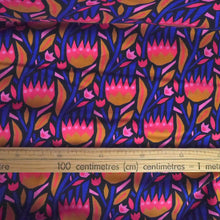 Load image into Gallery viewer, Organic cotton fabric displayed flat with ruler alongside bold flowers print