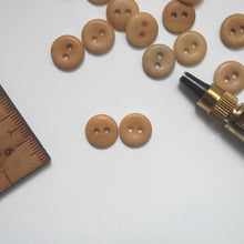 Load image into Gallery viewer, Two 2-hole corozo buttons, one showing smooth dome side, the other showing concave side