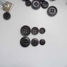 Load image into Gallery viewer, 4-hole corozo buttons shown in three different sizes, one side shows a smooth domed side, the other shows a flat with edged rim